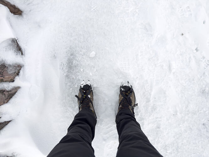 Crampons on ice exposed by wind-blown snow