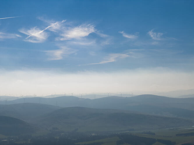 View south from Tinto with blue skies and wind turbines