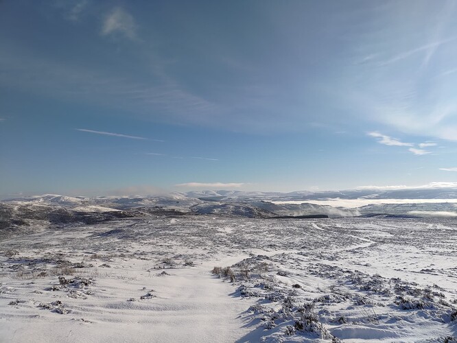 Snow covered hills east of Bala and cloud inversion following the river