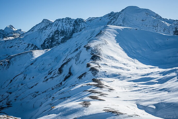 Plane over snowy peaks.