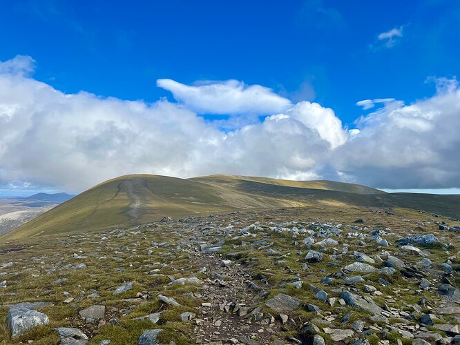 Walk across the top to the summit at the end