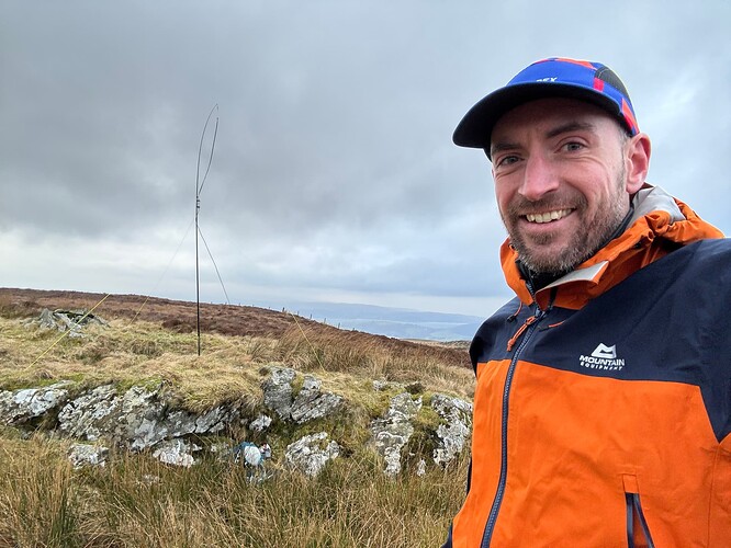 Summit selfie with antenna and mast in the background