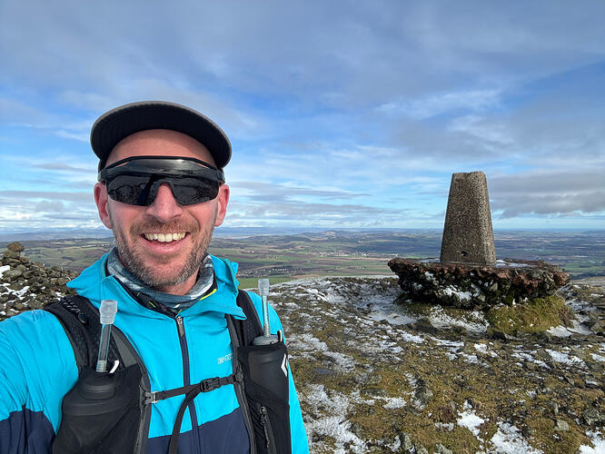 Selfie with the West Lomond summit trig point in the background