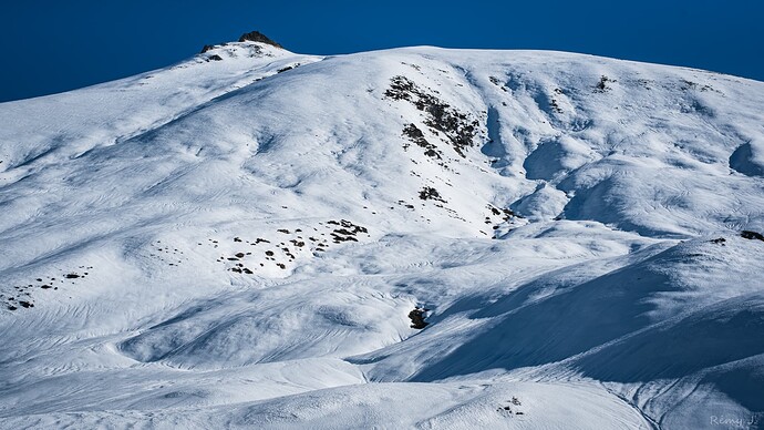 Snowy pastures with the summit in view.