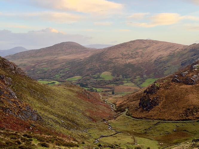 View from the gully west of the narrow Beara Way (Caha Pass). Round peaks of Barraduff Mountain (closer) and Killaha Mountain (further) can be seen on the other side of the pass.